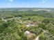 Scenic aerial view of a property nestled within lush greenery and mature trees, offering privacy and tranquility at 10502 Atlee St, New Port Richey, FL 34654