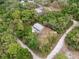 An aerial view of a single story home surrounded by mature trees on a corner lot at 10502 Atlee St, New Port Richey, FL 34654