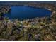 Gorgeous aerial view of a lake, with waterfront homes nestled among the trees at 10502 Atlee St, New Port Richey, FL 34654