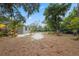 Expansive backyard with lush greenery and a well-maintained lawn surrounding the charming home at 10502 Atlee St, New Port Richey, FL 34654