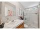 Bathroom offers a vanity with storage, a glass-enclosed shower, and a modern commode at 10502 Atlee St, New Port Richey, FL 34654
