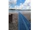 Beach access with a blue accessible pathway leading to the lake shore, creating ease of entry at 10502 Atlee St, New Port Richey, FL 34654