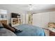 Bright bedroom with a large bed, ample storage with a wall of closets, and views into the en suite bathroom at 10502 Atlee St, New Port Richey, FL 34654