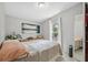 Comfortable bedroom with natural light, neutral walls, and plank floors creates a relaxing atmosphere at 10502 Atlee St, New Port Richey, FL 34654