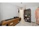 Bedroom with neutral walls and tile floors has closet and trophy display shelving at 10502 Atlee St, New Port Richey, FL 34654