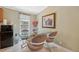 Cozy dining area features a glass table with seating for four, complemented by modern decor and natural light at 10502 Atlee St, New Port Richey, FL 34654