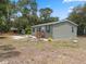 Exterior of a single Gathering home with mature landscaping and a shed in the rear at 10502 Atlee St, New Port Richey, FL 34654