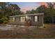 Charming single-story home featuring green shutters and landscaped with trees at 10502 Atlee St, New Port Richey, FL 34654