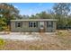 Exterior of the home with classic details, neat landscaping and an outbuilding at 10502 Atlee St, New Port Richey, FL 34654