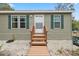 Charming home featuring a quaint front porch and inviting curb appeal with green shutters and a welcoming entrance at 10502 Atlee St, New Port Richey, FL 34654