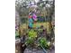 Unique garden with whimsical decor, an archway, and lush plantings at 10502 Atlee St, New Port Richey, FL 34654