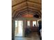 Interior view showcasing the unfinished walls and beams, door leading to the porch at 10502 Atlee St, New Port Richey, FL 34654