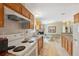 Open kitchen features wood cabinets, modern appliances, and a view into the dining area for easy conversation at 10502 Atlee St, New Port Richey, FL 34654
