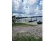Quaint lake pier and adjacent sandy beach with a personal watercraft ready for fun at 10502 Atlee St, New Port Richey, FL 34654