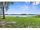 Lakeside bench on a grassy area, providing a serene spot to enjoy the view of the water at 10502 Atlee St, New Port Richey, FL 34654