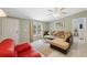 Bright living room featuring a plush sectional sofa, light wood-look floors, and a welcoming atmosphere at 10502 Atlee St, New Port Richey, FL 34654