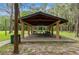 Open-air pavilion with picnic tables, offering a shaded gathering space in a natural setting at 10502 Atlee St, New Port Richey, FL 34654