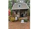 Charming backyard shed with a porch offers a perfect getaway at 10502 Atlee St, New Port Richey, FL 34654