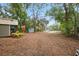 Wide backyard view showcasing landscaping, outbuildings, and an inviting rural setting at 10502 Atlee St, New Port Richey, FL 34654