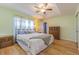Bright bedroom with a tray ceiling, wooden floors, and a cozy ambiance at 11311 Corey Pavin Ln, San Antonio, FL 33576