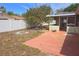 Spacious backyard features a patio, mature tree and a white privacy fence at 11625 Constance Dr, Port Richey, FL 34668