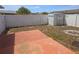 Backyard features a fenced perimeter, storage shed, and a red brick paved area at 11625 Constance Dr, Port Richey, FL 34668