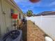 Side yard with utility storage, equipment and fencing providing a functional outdoor space at 11625 Constance Dr, Port Richey, FL 34668