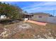 Fenced backyard with solar panels, patio and large tree offers a private outdoor space at 11625 Constance Dr, Port Richey, FL 34668