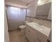 Bathroom features a white sink and a sliding glass door shower at 11625 Constance Dr, Port Richey, FL 34668