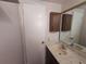 Classic bathroom with sink, cabinet and mirror providing basic functionality with traditional design at 11625 Constance Dr, Port Richey, FL 34668