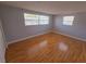 Bright bedroom features hardwood floors and natural light from the two windows at 11625 Constance Dr, Port Richey, FL 34668