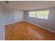 Cozy bedroom with hardwood floors, window, and closet for storage at 11625 Constance Dr, Port Richey, FL 34668
