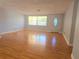 Bright living room with hardwood floors and ample natural light streaming through the large windows at 11625 Constance Dr, Port Richey, FL 34668