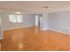 Spacious living room featuring beautiful hardwood floors and neutral paint colors at 11625 Constance Dr, Port Richey, FL 34668