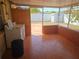Outdoor patio with washer, dryer, tile flooring and view of fenced backyard at 11625 Constance Dr, Port Richey, FL 34668