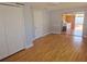 Spacious room with hardwood floors, closet doors and access to the patio at 11625 Constance Dr, Port Richey, FL 34668