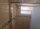 Updated shower with dual showerhead and bench, complemented by neutral tile at 11625 Constance Dr, Port Richey, FL 34668