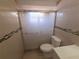 Bathroom shower features a sliding glass door and tiled surround at 11625 Constance Dr, Port Richey, FL 34668