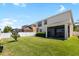 Backyard with a covered patio, white fence, and well maintained lawn at 11760 Winterset Cove Dr, Riverview, FL 33579
