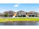 Backyard with a lake view, white fence, and well maintained lawn at 11760 Winterset Cove Dr, Riverview, FL 33579