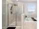 Elegant bathroom featuring a glass-enclosed shower, a soaking tub, and a view from the window at 11760 Winterset Cove Dr, Riverview, FL 33579