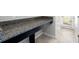 Close up of granite countertop in bathroom next to tiled floors and white bathroom door at 11760 Winterset Cove Dr, Riverview, FL 33579
