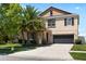 Two-story home featuring stone accents, well-manicured lawn, mature landscaping and an attached two car garage at 11760 Winterset Cove Dr, Riverview, FL 33579