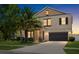 Two-story home featuring stone accents, well-manicured lawn, mature landscaping and an attached two car garage at 11760 Winterset Cove Dr, Riverview, FL 33579