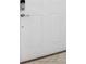 White front door with a modern door knob and security door knob at 11760 Winterset Cove Dr, Riverview, FL 33579