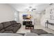 Comfortable living room with tile flooring, a ceiling fan, entertainment center, and staircase leading to the second floor at 11760 Winterset Cove Dr, Riverview, FL 33579