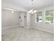 Spacious living room with modern lighting and ceramic tile floors at 11760 Winterset Cove Dr, Riverview, FL 33579