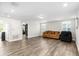 Bright and airy living room featuring hardwood floors, neutral walls, and multiple seating options at 11760 Winterset Cove Dr, Riverview, FL 33579