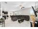 Spacious living room with tile flooring, modern furniture, and a view into the open-concept kitchen and dining area at 11760 Winterset Cove Dr, Riverview, FL 33579