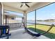 Relaxing screened-in patio with ceiling fan, swing bench, hammock and peaceful backyard views at 11760 Winterset Cove Dr, Riverview, FL 33579